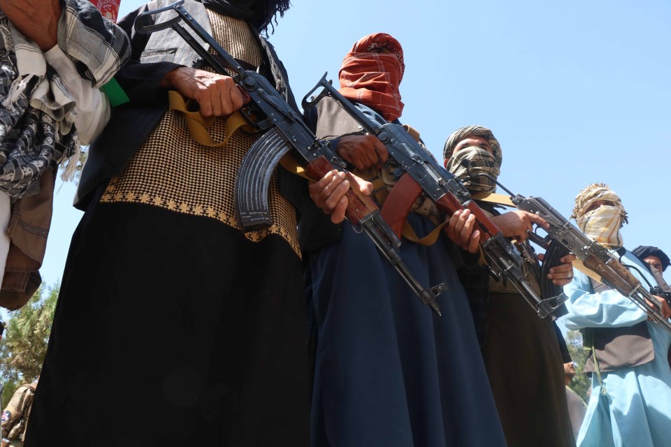 Afghan civilians show arms as they vow to to defend their regions against the Taliban