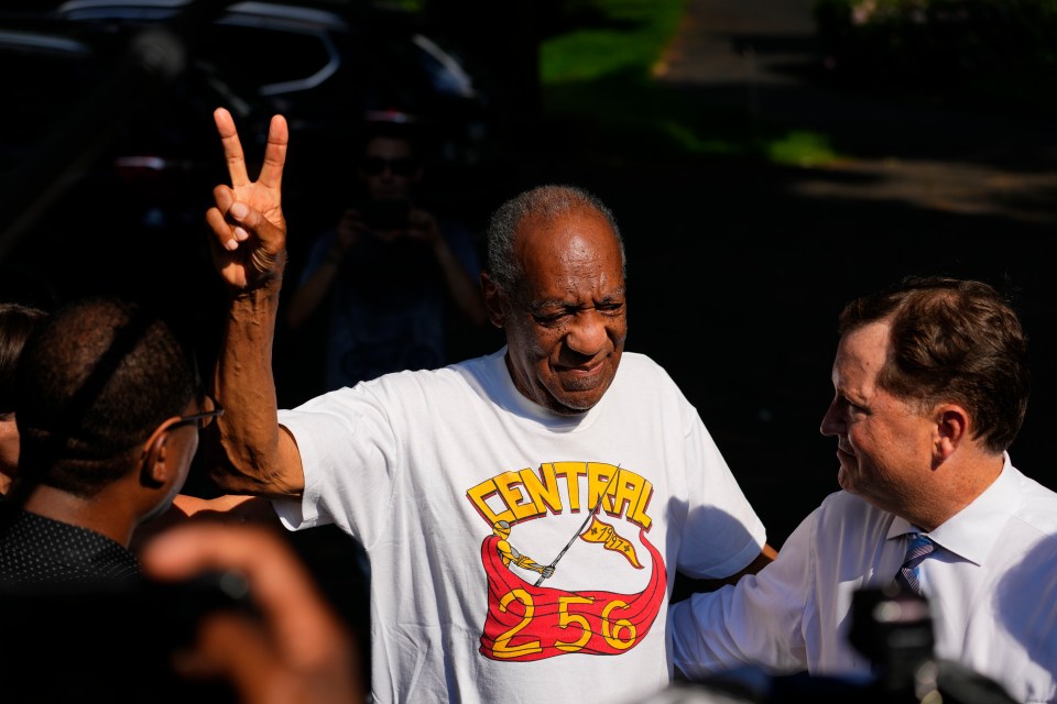 Cosby flashing a V for victory sign