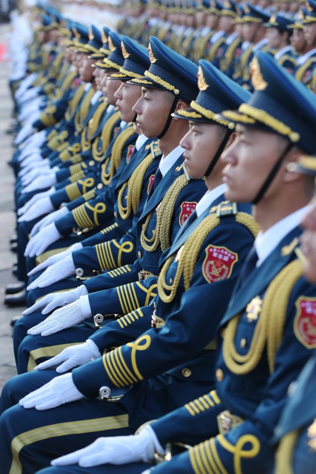 Chinese soldiers sit at attentions during the celebrations in Tiananmen Square