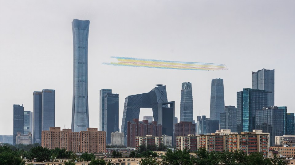 Military jets fly over the central business district in Beijing to mark the centenary