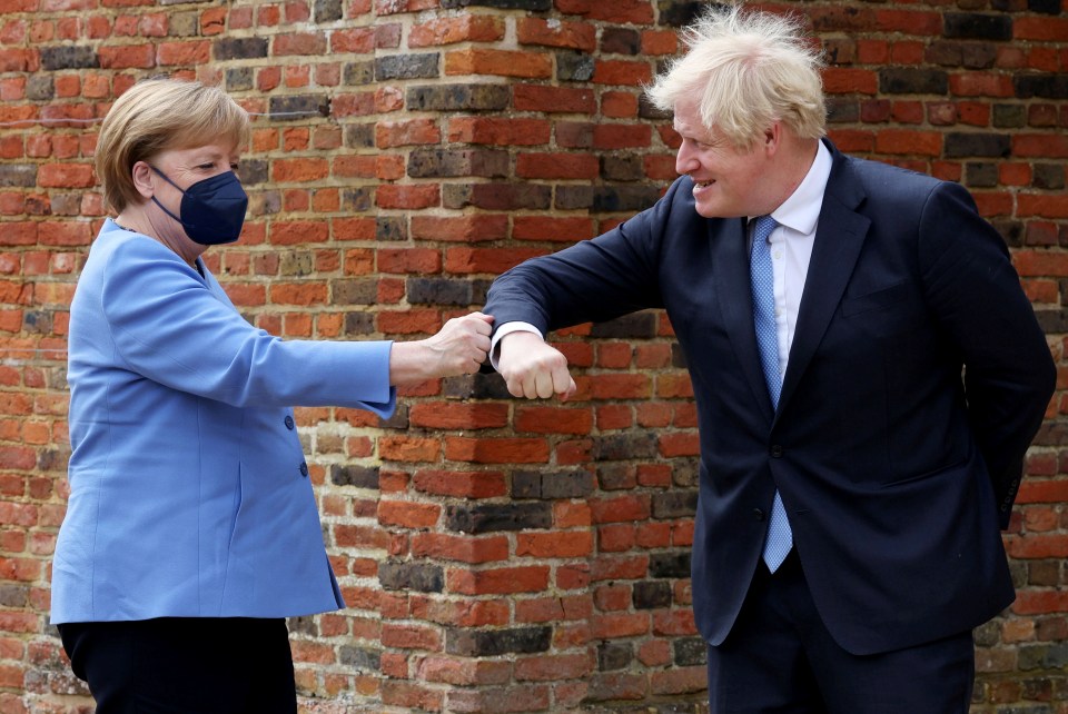 German Chancellor Angela Merkel bumps elbows with Britain's Prime Minister Boris Johnson before their bilateral meeting on July 2