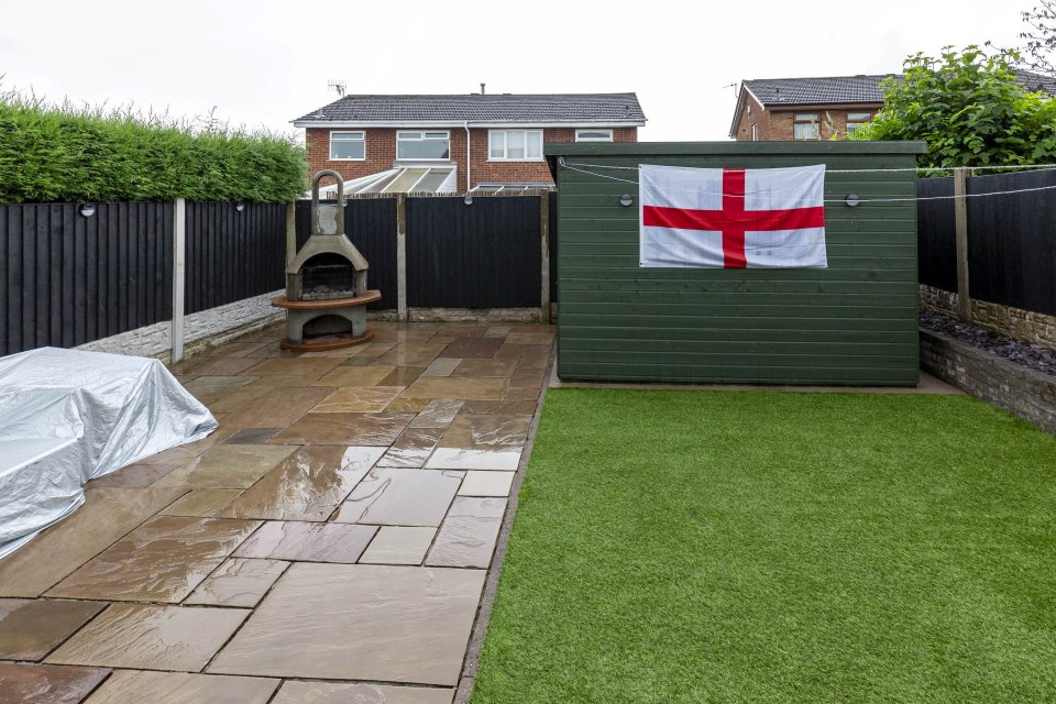 There's a patio to the back of the house, as well as a patch of astro turf