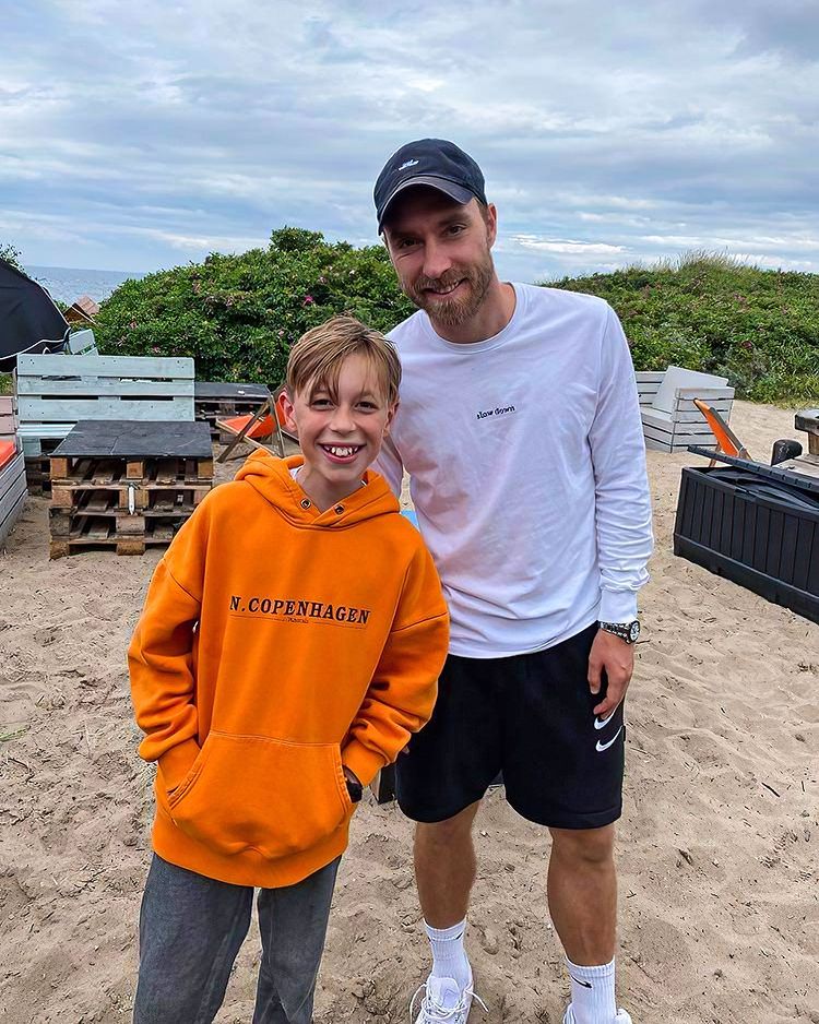 Eriksen took a photo with a young fan on a beach in Denmark