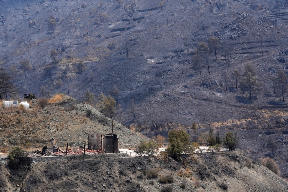 A burned house is seen amongst the devastation