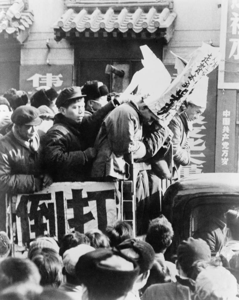 Chinese Red Guards publicly parade their victims, wearing dunce caps and signs proclaiming their crimes.... in some cases these 'class enemies' were reportedly eaten