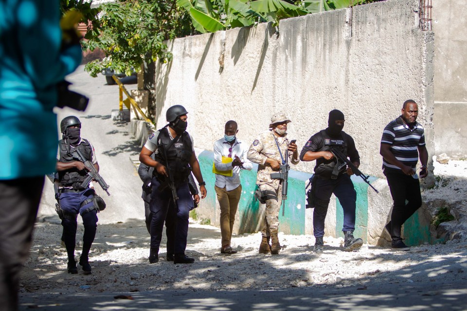 Police agents work near Moise's presidential home