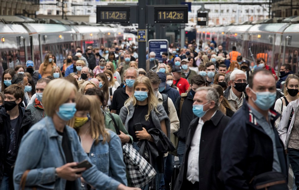 Passengers cover up at Kings Cross Station in London on Saturday