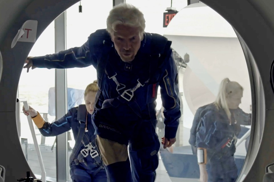 Richard Branson and Virgin Galactic crew members enter the company's passenger rocket plane, the VSS Unity