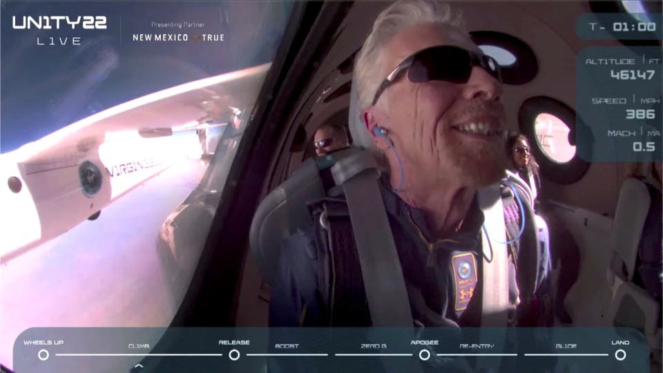 Billionaire Richard Branson smiles on board VSS Unity before starting its untethered ascent to the edge of space