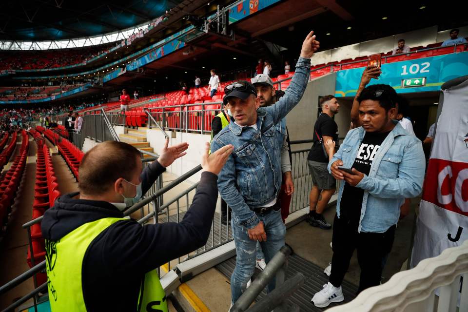 A steward speaks to fans, some of whom were were said to be without a ticket, ahead of the UEFA EURO 2020 final football match (file image)