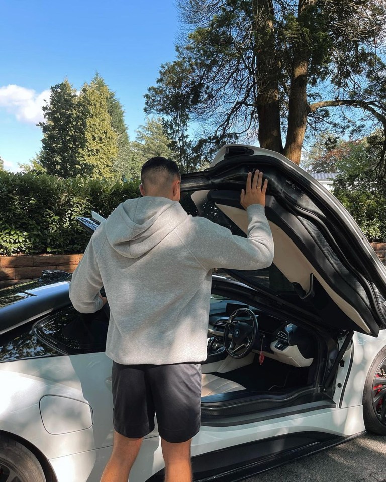 The star posed in front of the £120k BMW i8