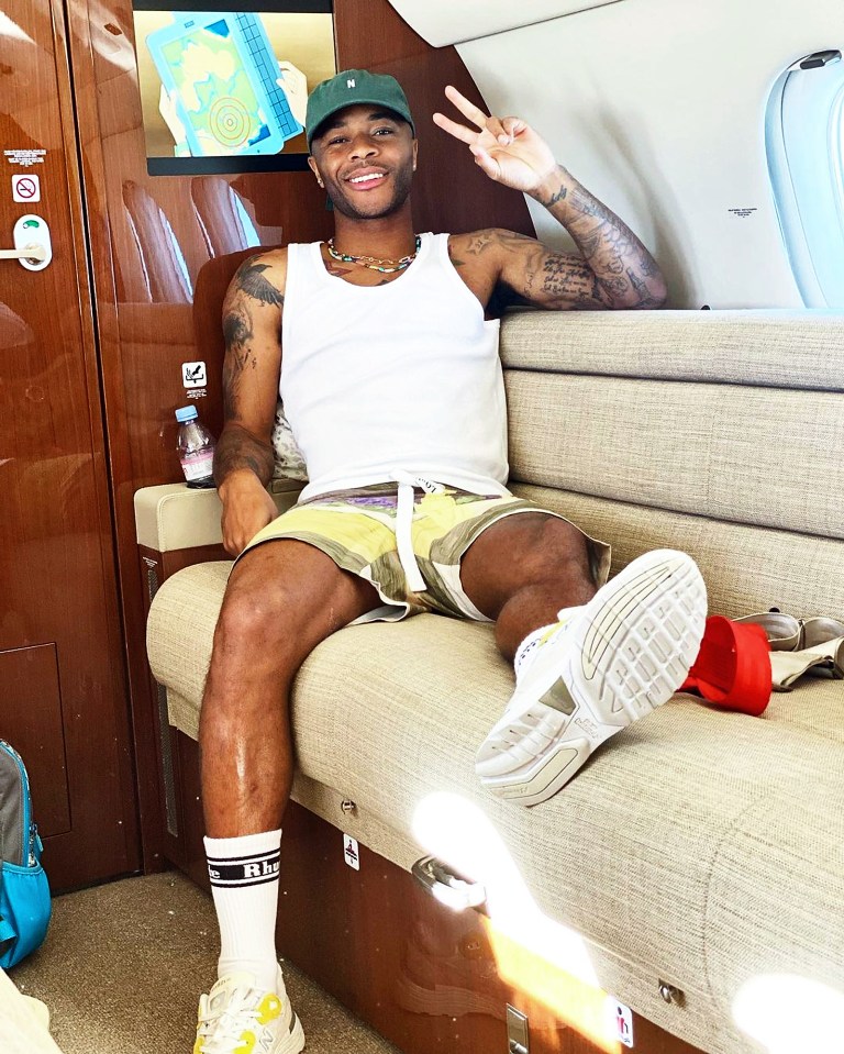 Raheem Sterling relaxes in a cabin lounge as he heads off on holiday