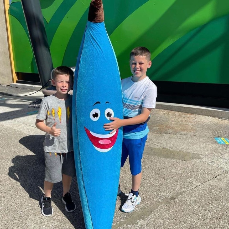 The youngsters posed with a huge surfboard