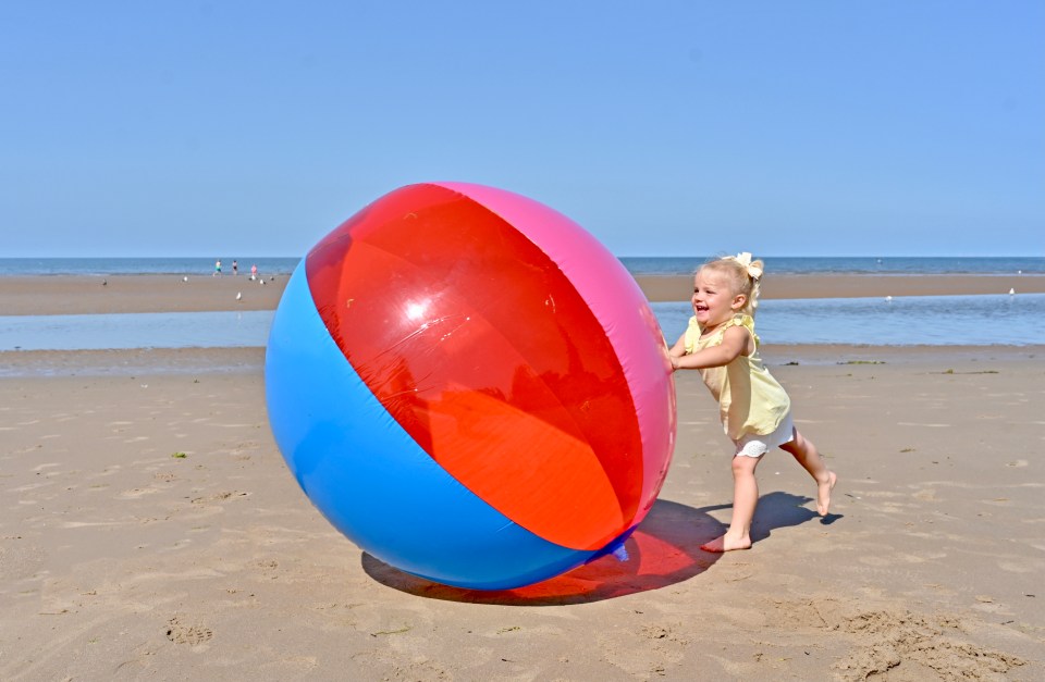 While Rae Pitham, 2, played on Blackpool beach