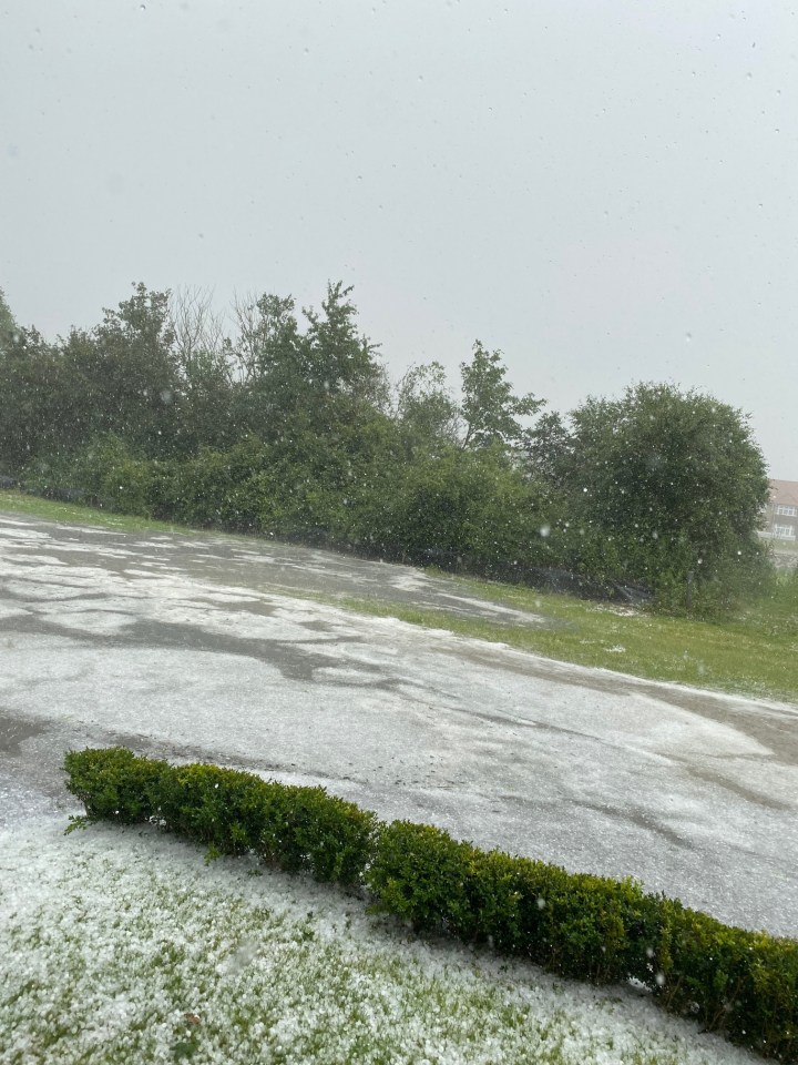 Thunderstorms and hail 'the size of marbles' batter 32C Britain as roads melt