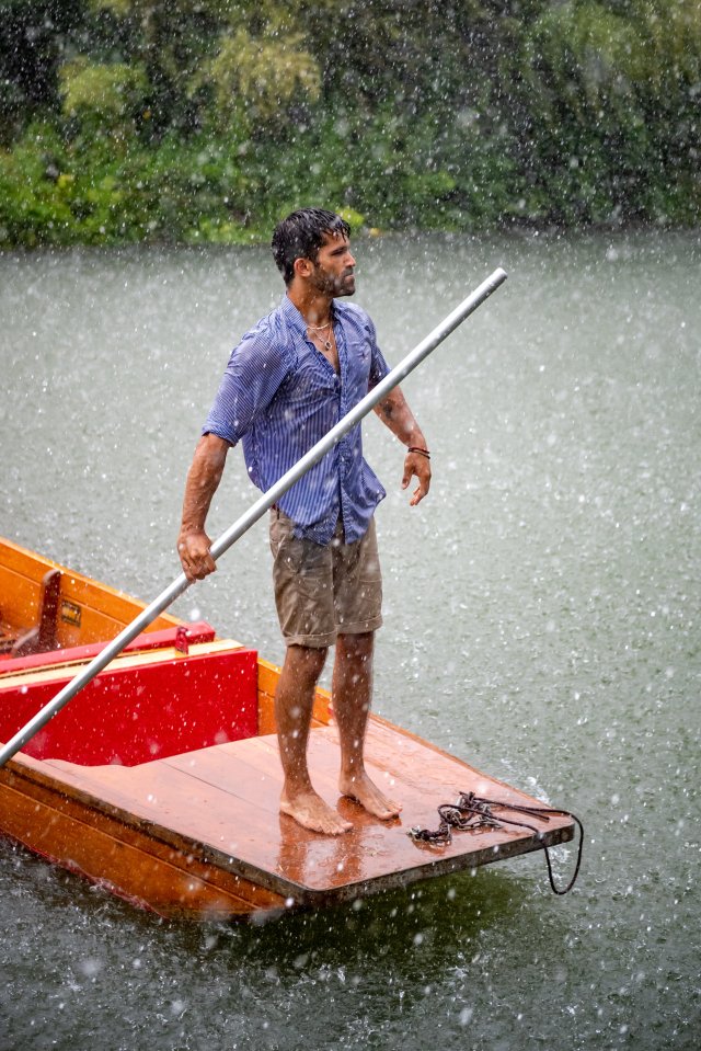 A man in a punt gets caught in a flash hail storm in Cambridge