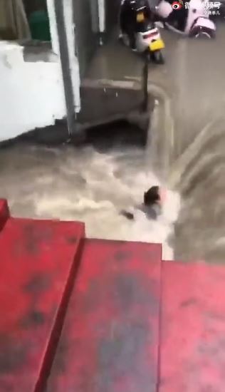 A woman became caught in raging floodwater