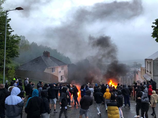 Gangs of yobs set fire to cars and rolled them down a hill in Swansea