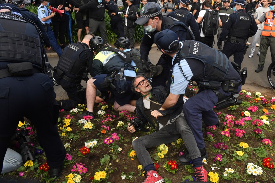 Protesters are arrested by the police at Sydney Town Hall during the 'World Wide Rally For Freedom' anti-lockdown rally at Hyde Park