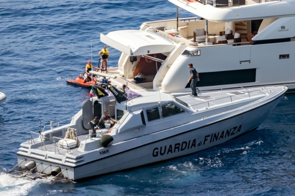 The Guardia Finanza police pull up beside the Beckhams’ luxury yacht