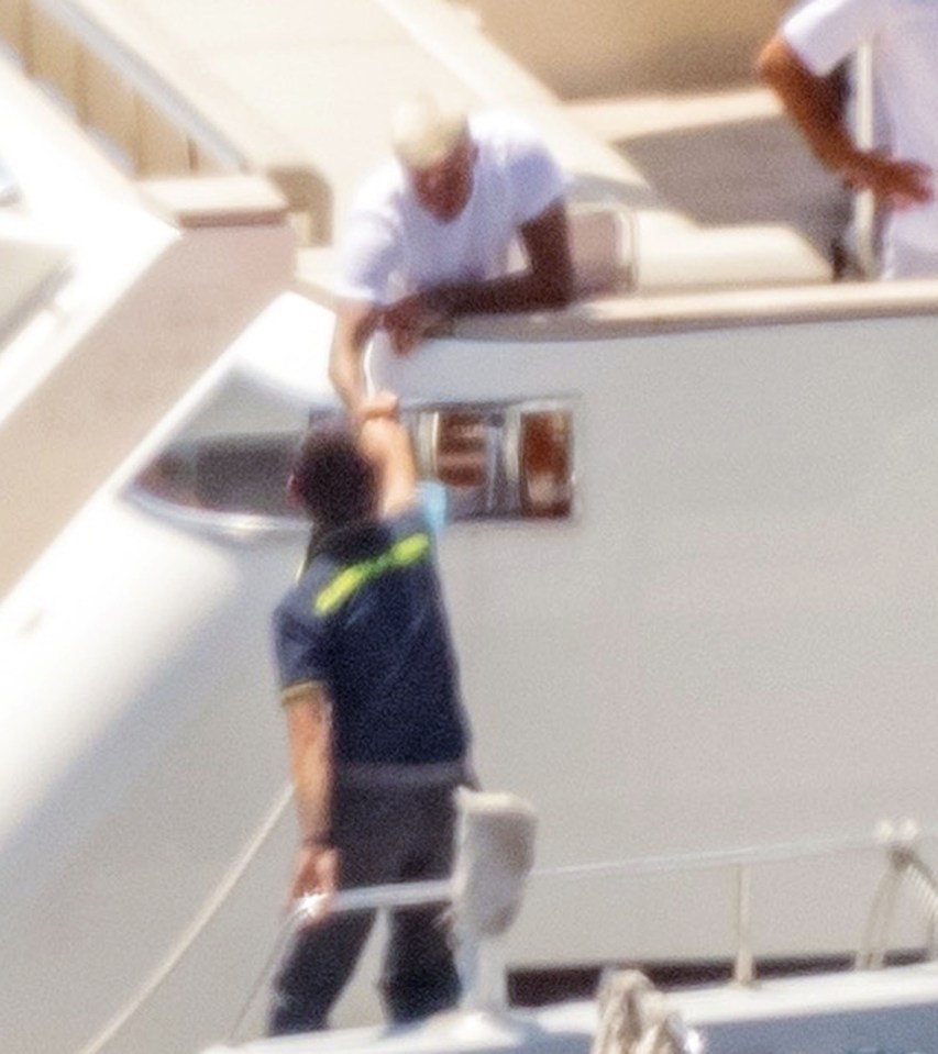 David Beckham fist-bumps an Italian cop after being quizzed about his kids jet-skiing on holiday