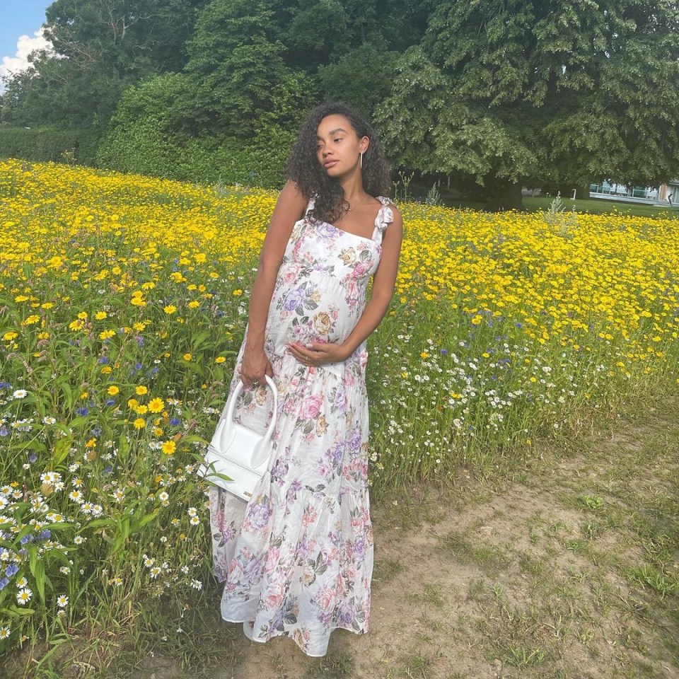 The star was also seen cradling her growing bump as she posed for a snap in a field