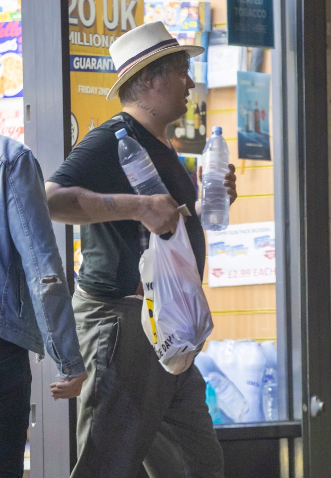 The rocker was seen carrying a white plastic bag full of snacks and carried bottles of water