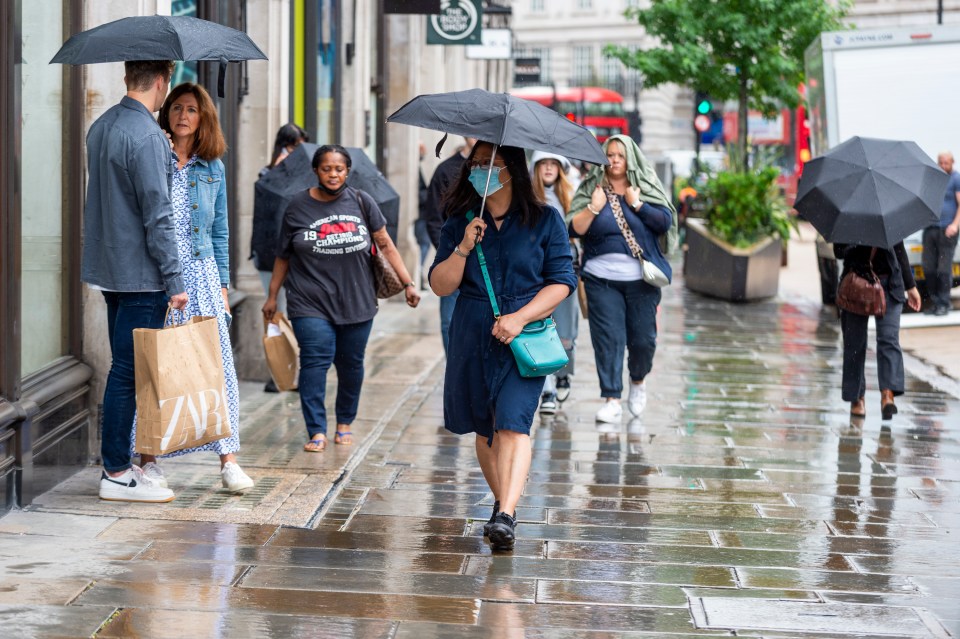 People out shopping during a rain shower on London's Regent Street