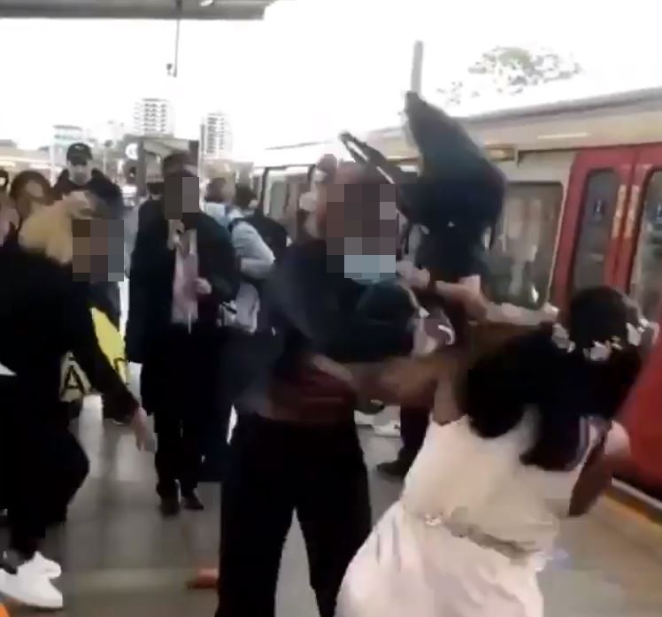 A woman dressed in black threw her bag at the glamorous woman in the flower crown