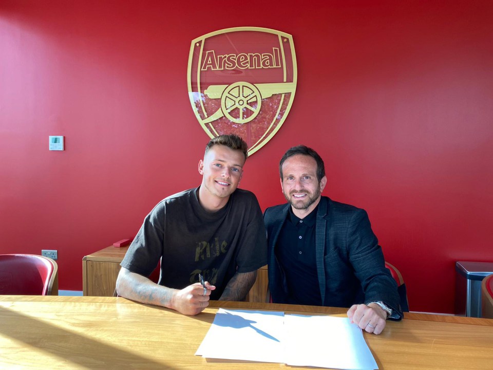 White was pictured signing the deal alongside agent Alex Levack