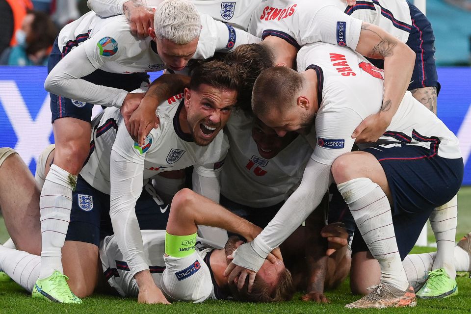 Harry Kane, bottom, celebrates with team mates after scoring against Denmark