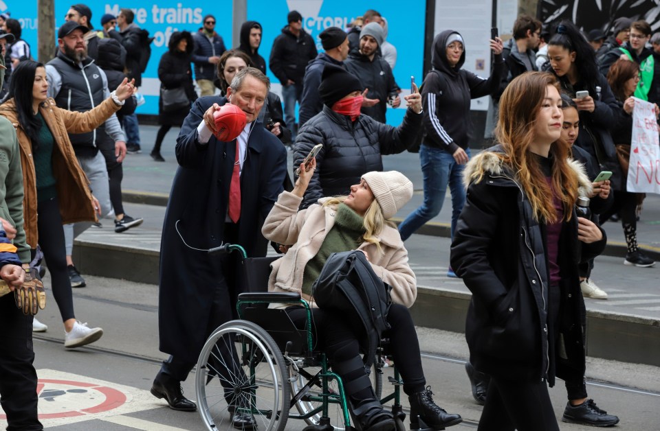 Protesters walk down Swanston Street during a World Wide rally for freedom on today in Melbourne