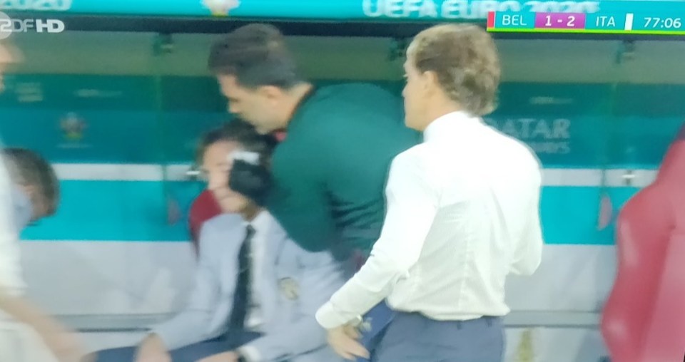 One of Roberto Mancini's backroom team was tended to by the physio during Italy's win over Belgium