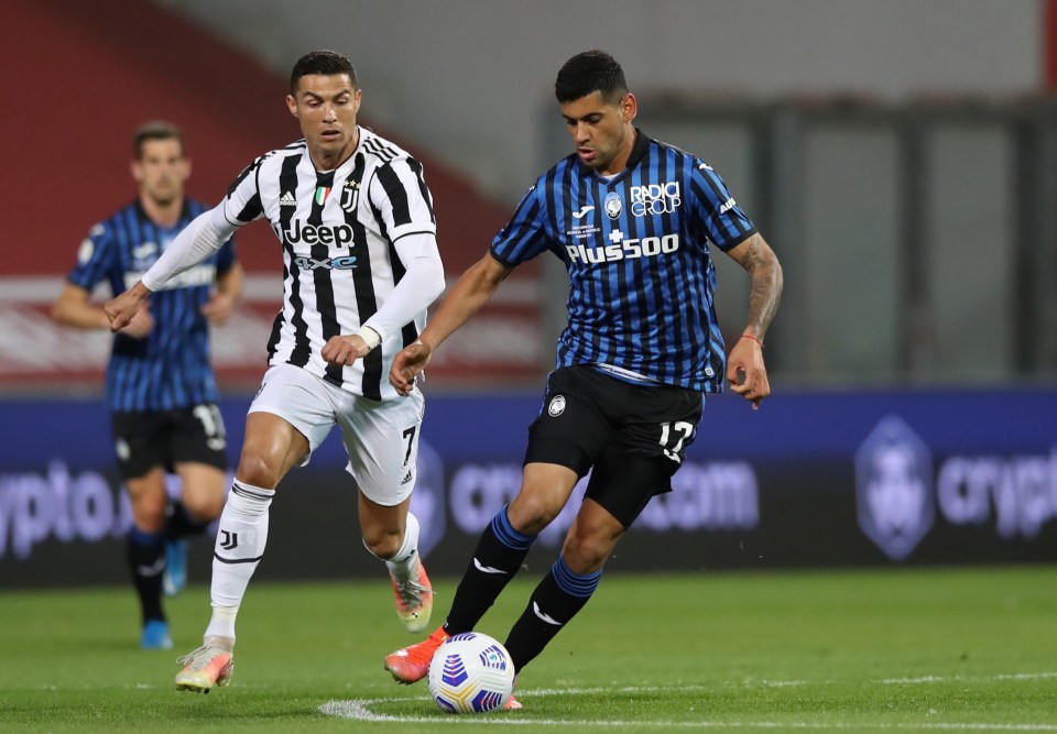 Cristian Romero tussles with Cristiano Ronaldo