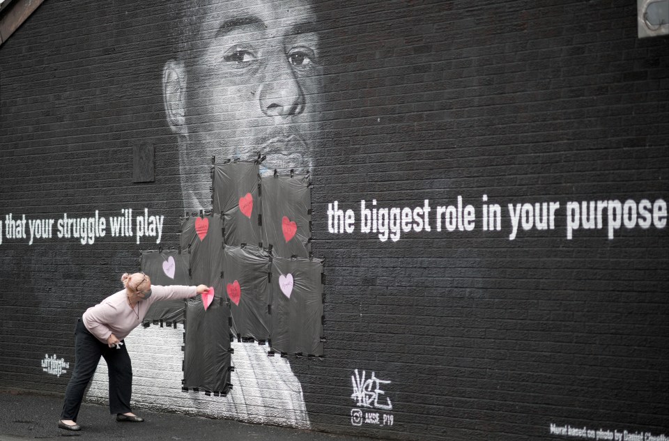 Local residents put messages of support on the mural for Marcus Rashford