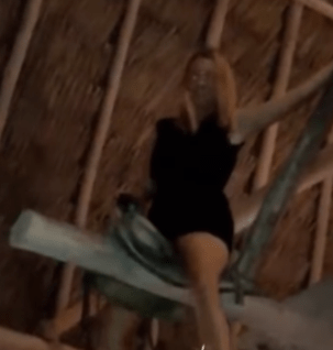 Jasmine Hartin is pictured riding a saddle haging in the rafter of a bar