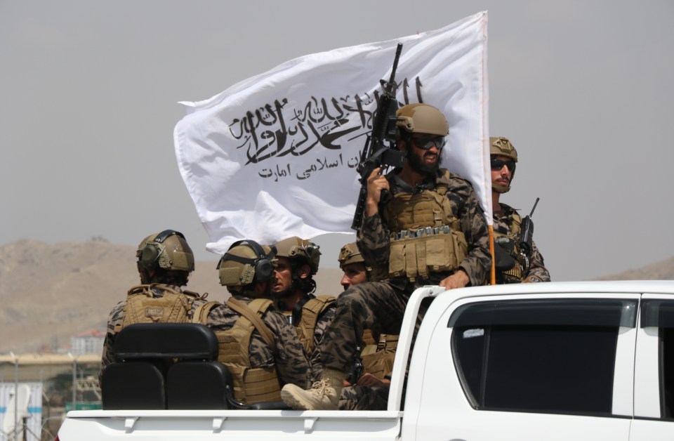 Taliban decked out in American gear and flying their flag take control of Hamid Karzai after the last US forces evacuated and the 20 year war ended