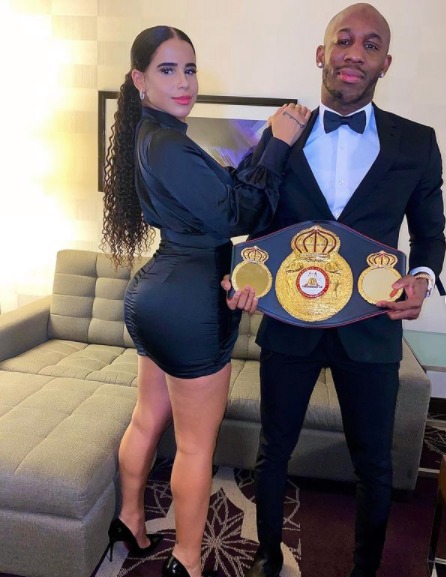 Yordenis Ugas holds his WBA belt next to his partner