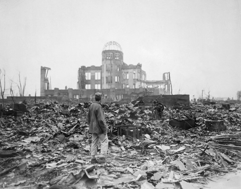 A man walks amongst the ruins of Hiroshima