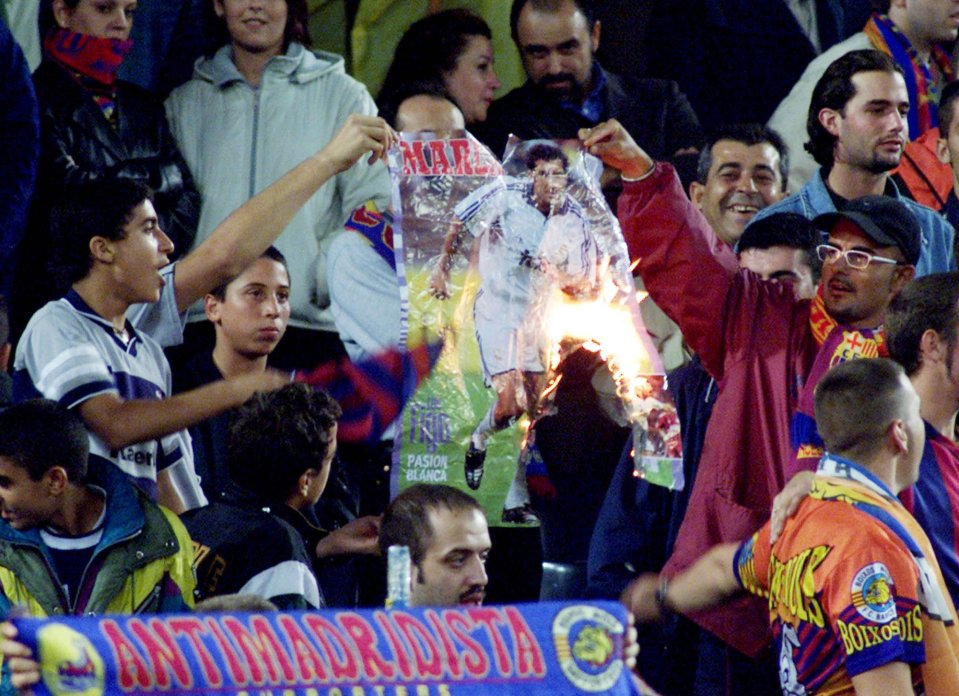 Barcelona fans burn a poster of former hero Luis Figo at the Nou Camp