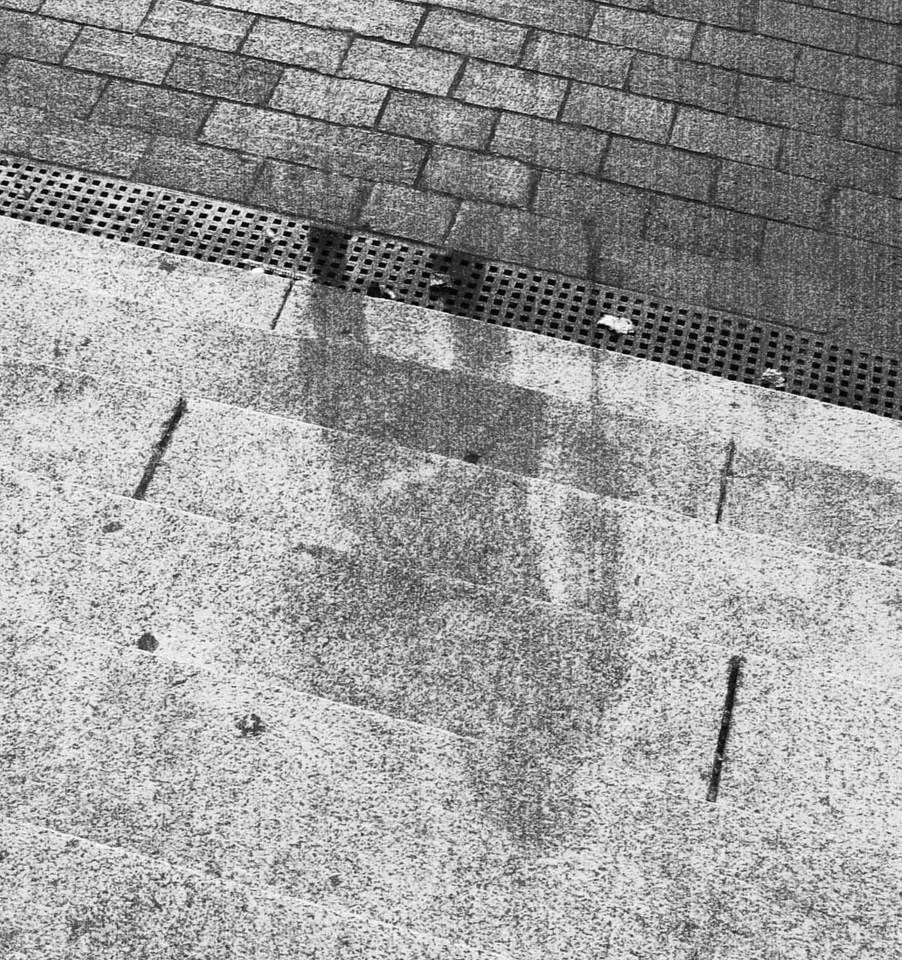 People's shadows were burned onto the pavement - this appears to have been a man with a cane