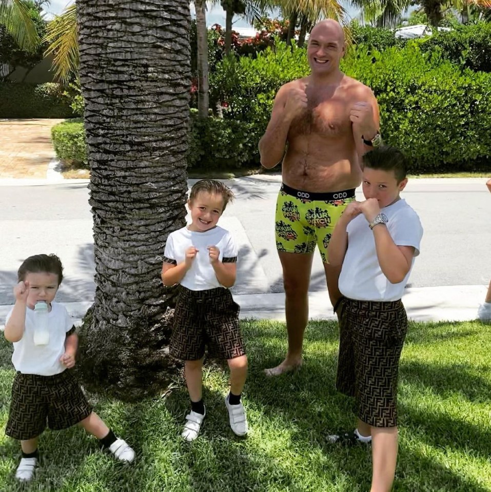 The boxer pictured with his three sons (L-R): Prince Adonis Amaziah, Prince Tyson II and Prince John James