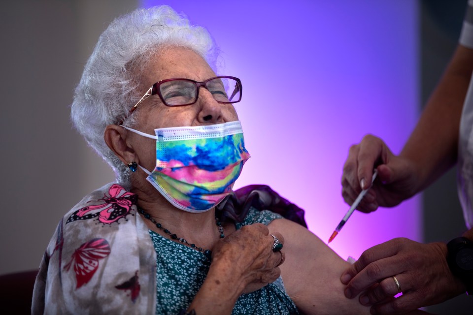 An elderly woman getting her booster jab in Israel earlier this month