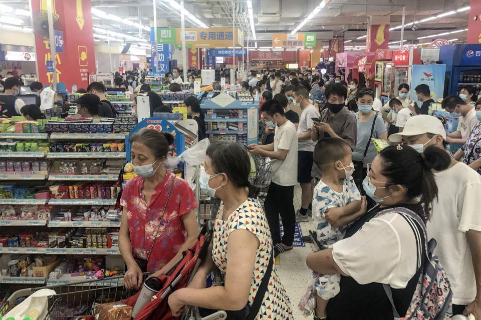 Crowds buying items at a supermarket in Wuhan where coronavirus emerged