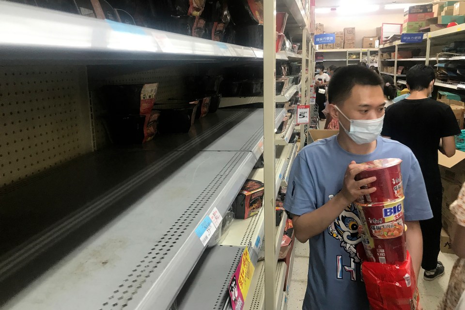 Shelves are empty as residents rush to stock up on necessities in Wuhan