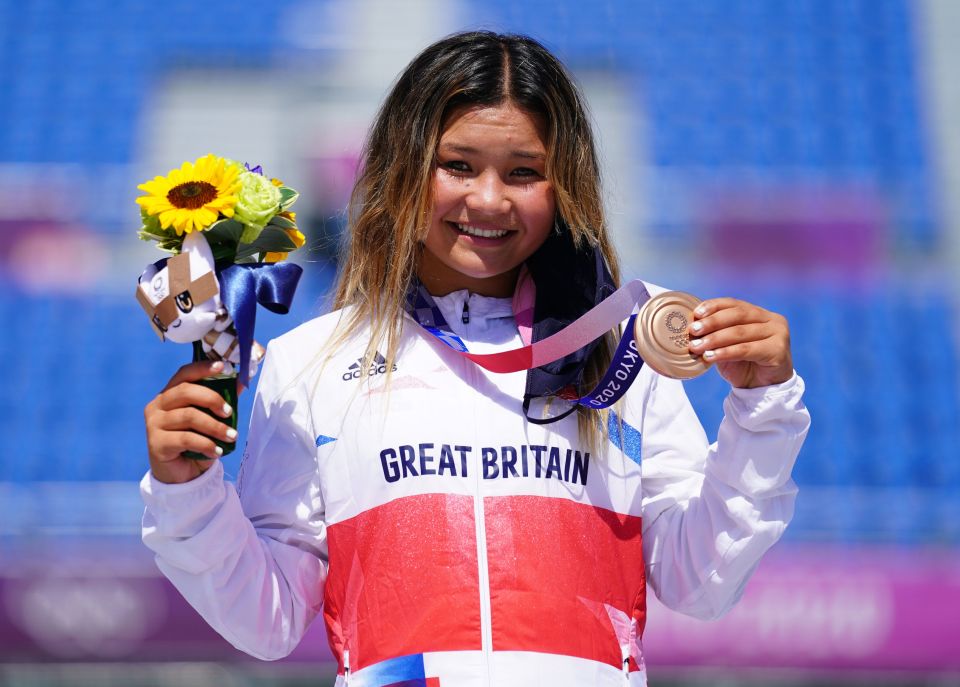 The 13-year-old celebrates with her bronze medal