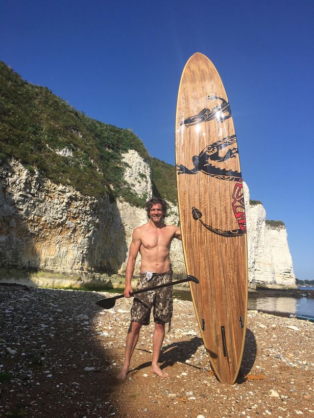 Anthony Robins said the pair swam under his paddleboard near Hengistbury Head