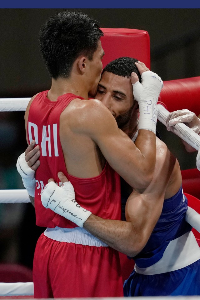 The fighters embrace after their gold medal bout