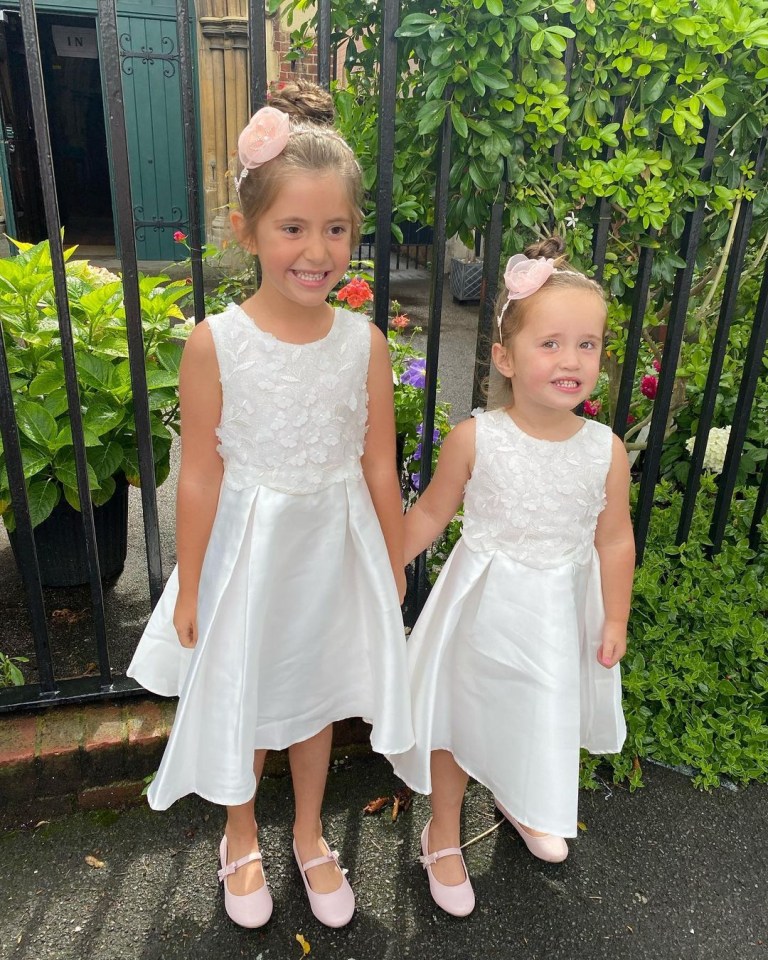 Ella, six, and Mia, three, looked adorable in their white gowns