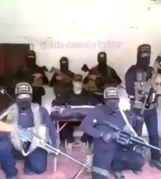 The footage features a number of heavily armed people wearing masks